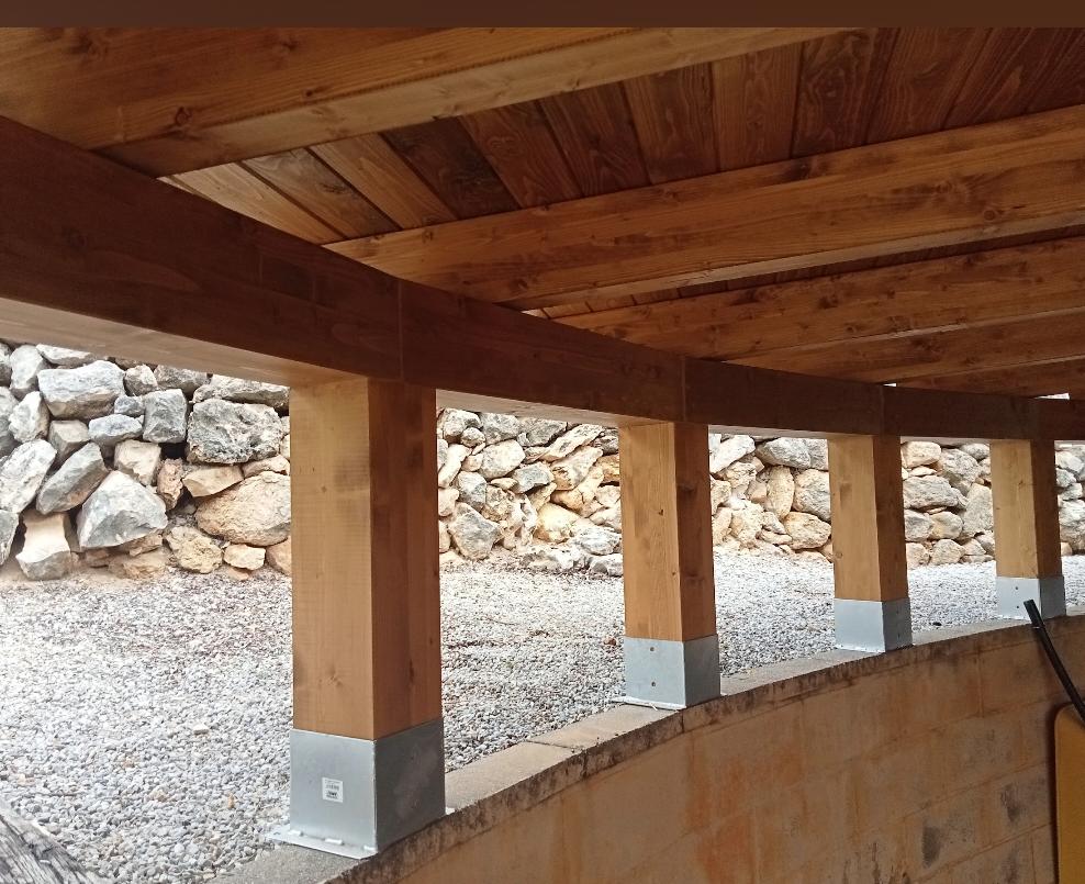 Covered parking with stone wall